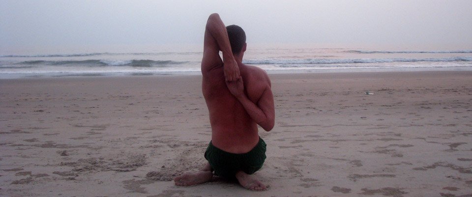 Tomek Kucharski demonstruje pozycję gomukhasana